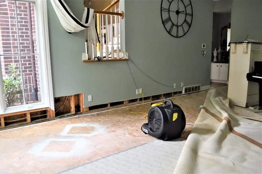 Air mover beside opened wall bases in a living room