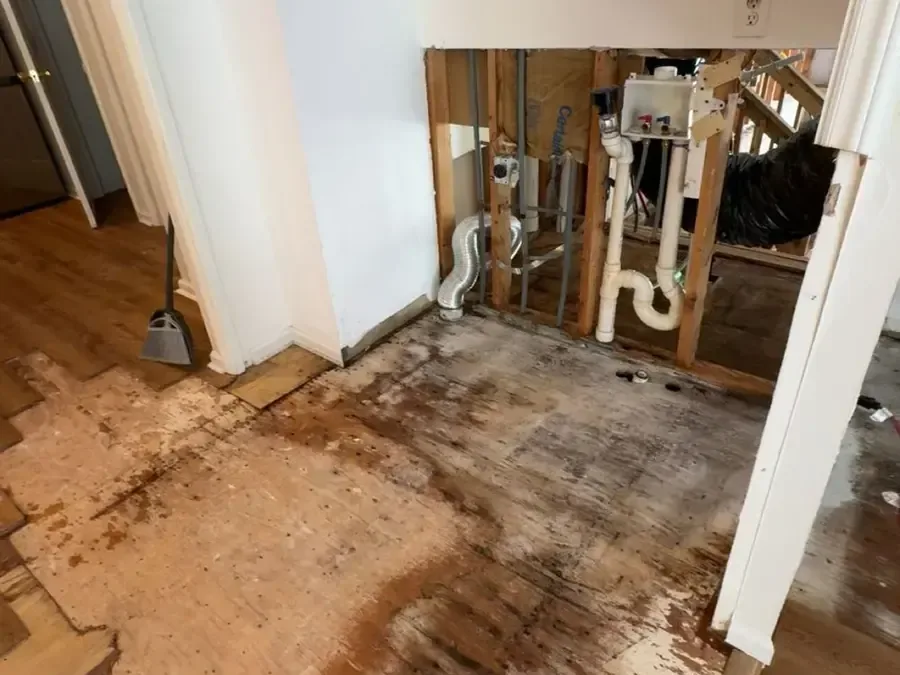 Wall opened around the plumbing with the wet flooring pulled up