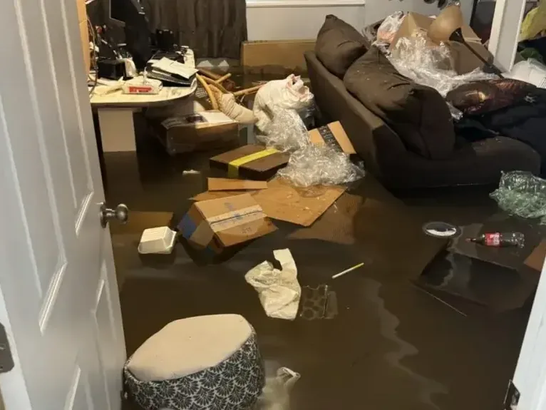 Flood water covering a furnished living room floor